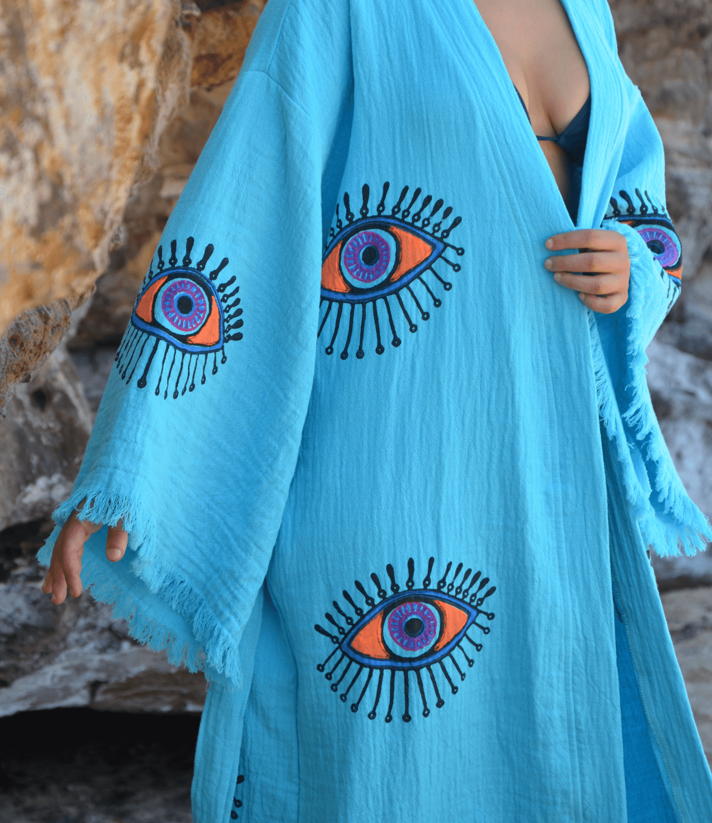 Evil Eye Kaftan Robe in turquoise with hand-painted eye patterns, perfect for elegant loungewear or beachwear.