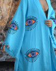Evil Eye Kaftan Robe in turquoise with hand-painted eye patterns, perfect for elegant loungewear or beachwear.