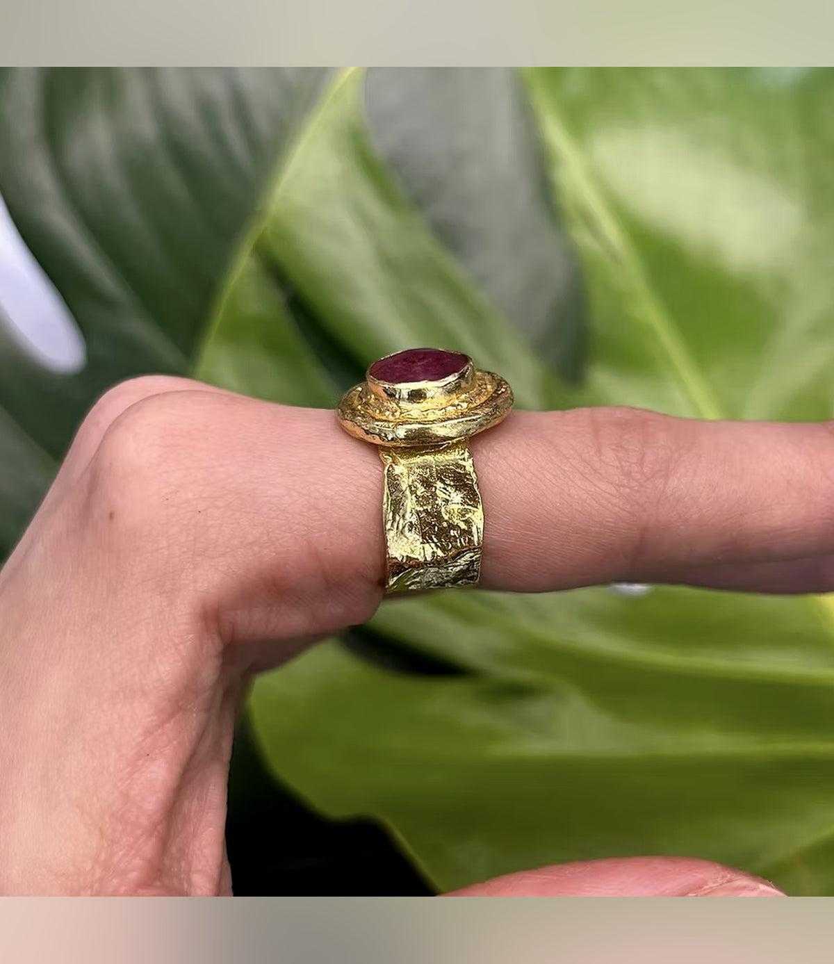 Side view of the Rhea Red Statement Ring showing its raised setting and textured gold-tone band