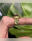 Side view of the Rhea Red Statement Ring showing its raised setting and textured gold-tone band
