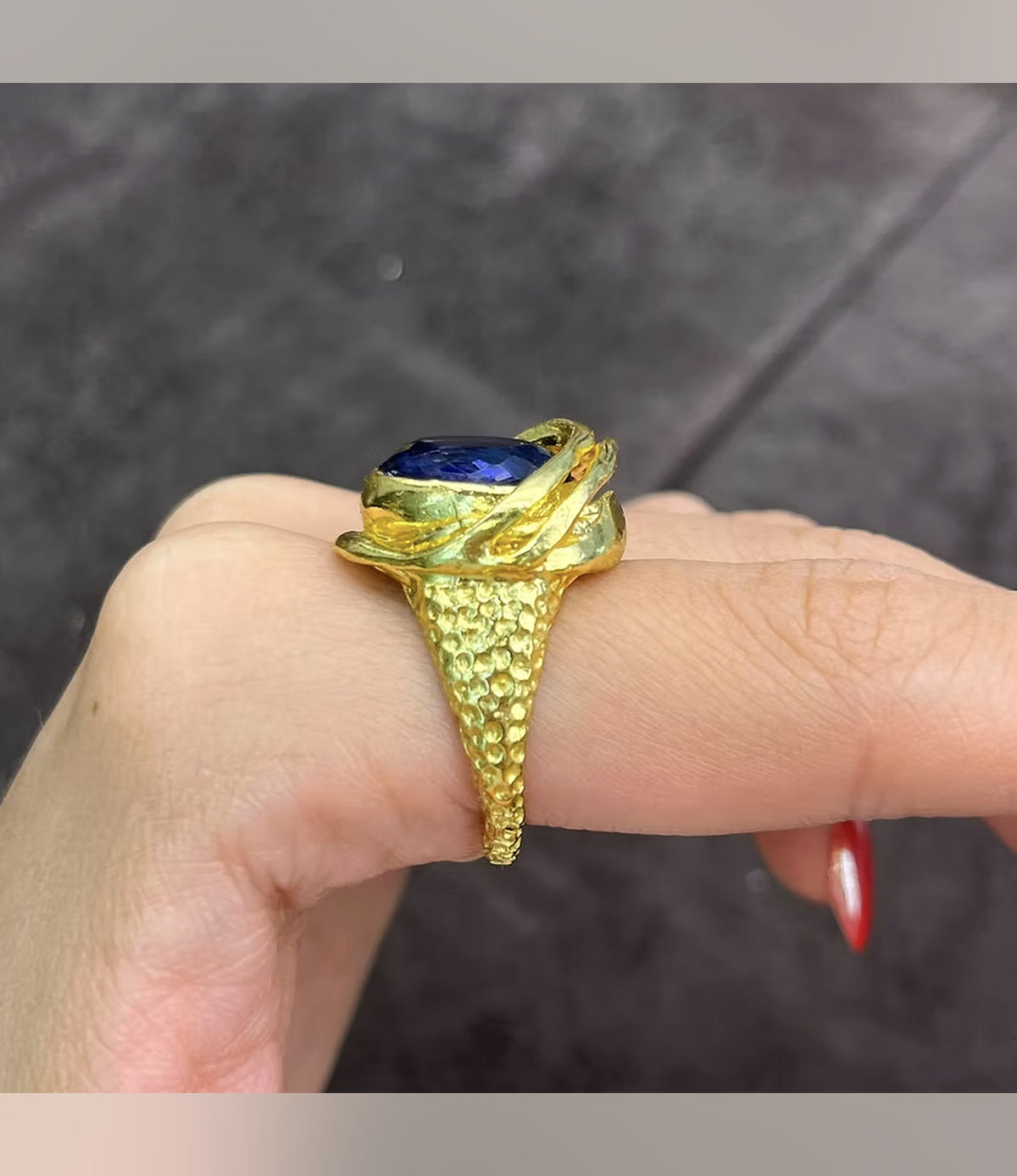 Side view of the Saphira Amethyst Statement Ring showing its raised setting and textured gold-tone band