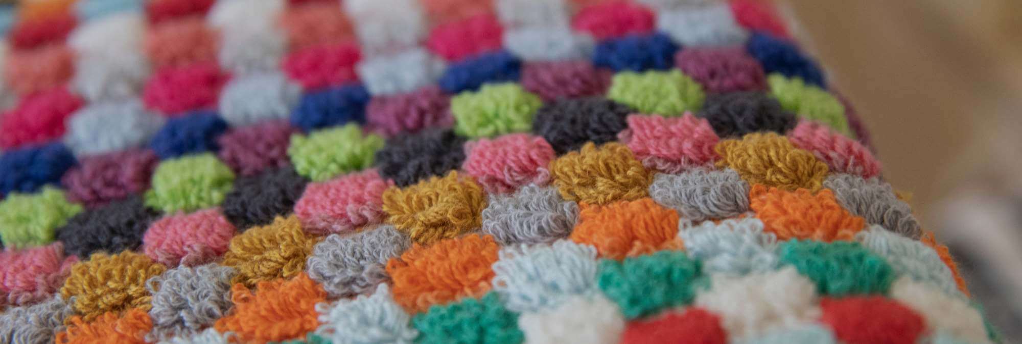 Multicolored crocheted towel with a geometric pattern