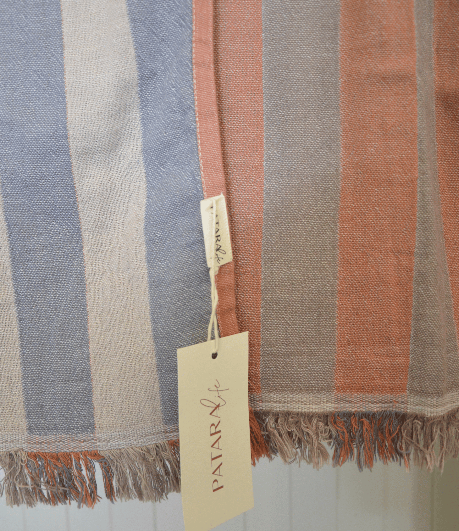 Striped fabric with a brand tag on a light background