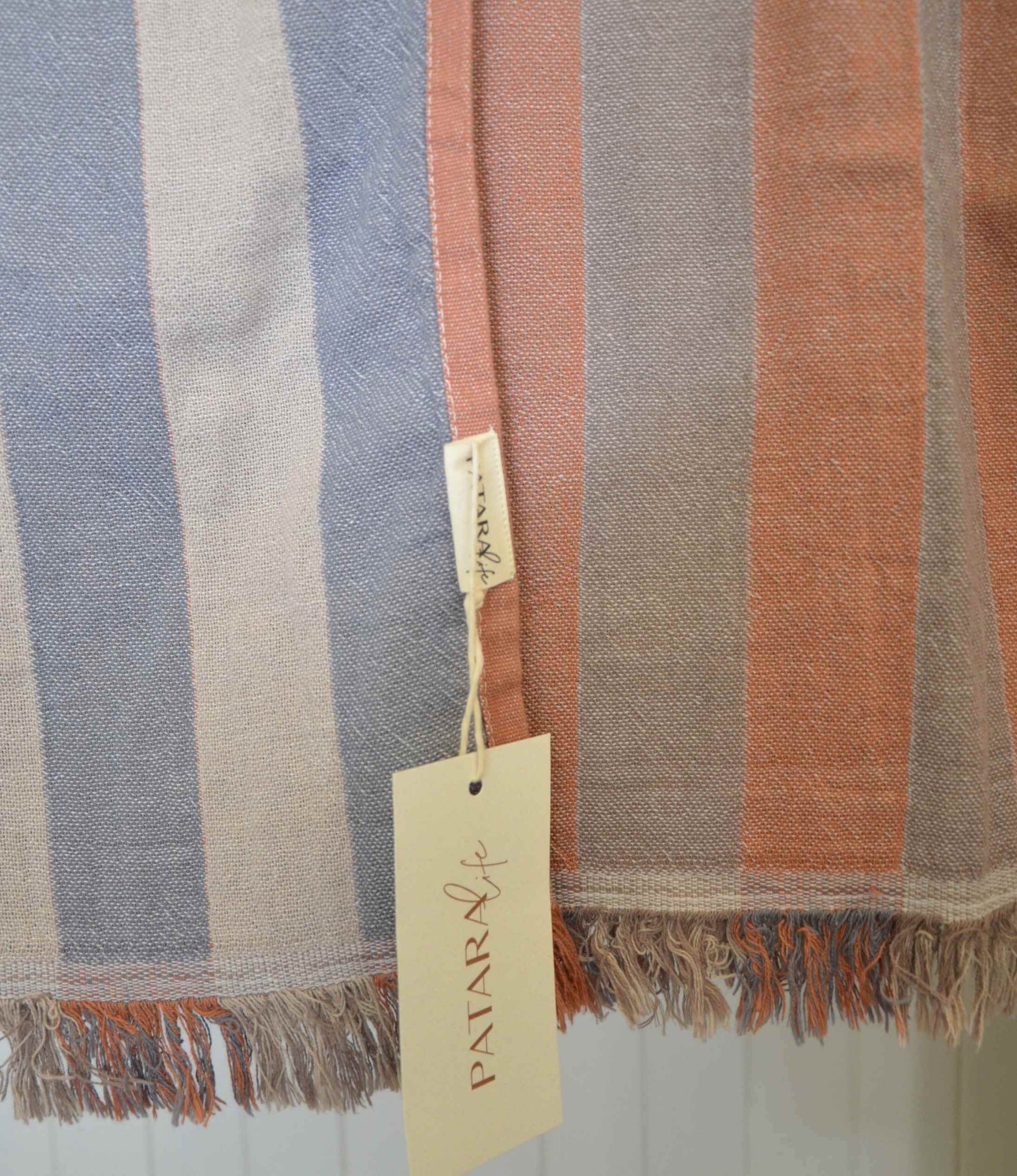 Striped fabric with a brand tag on a light background