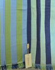Striped cotton towel with blue, green, and white colors and a visible brand tag.