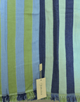 Striped fabric with green, blue, and navy colors and a visible brand tag.