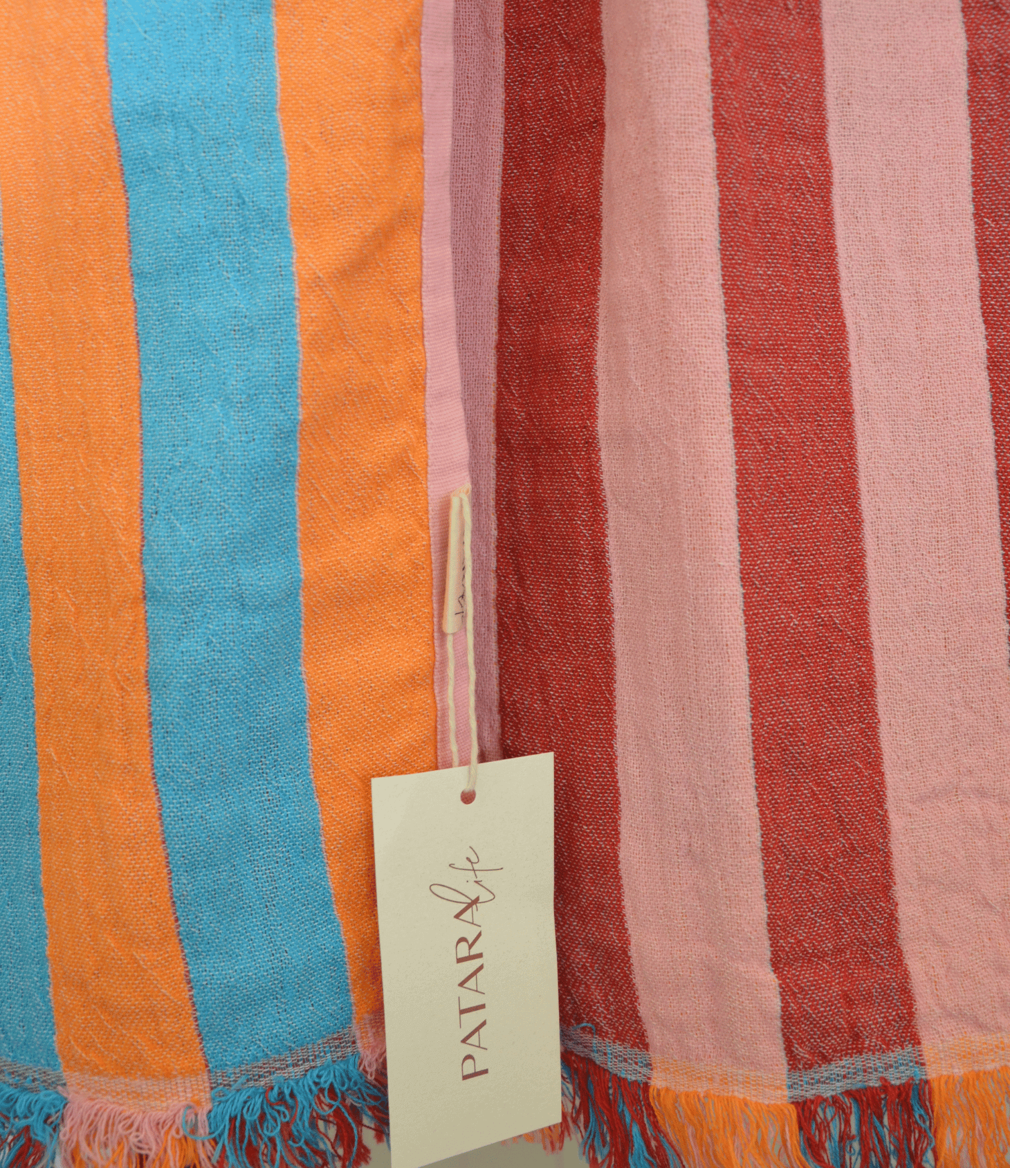 Striped fabric with a Patara label, featuring colors like blue, orange, and pink.