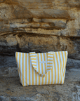 yellow beach tote bag on a beach rock cliff