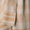 Close up of a linen blanket with copper stripes and dots