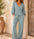 Pale blue wrap blouse with a side tie and gathered long sleeves, styled with matching drawstring pants.