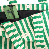 close up of pocket and snap detail of green and white beach bag