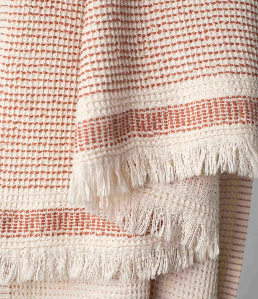 A dotted Turkish cotton "Kalkan" beach towel in copper red
