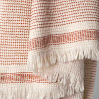 A dotted Turkish cotton "Kalkan" beach towel in copper red
