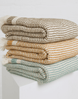 Three "Kalkan" beach towels folded on top of each other