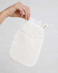 A Turkish Exfoliating glove help up by finger tips