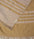 Close up of a mustard yellow linen & cotton premium throw layed flat