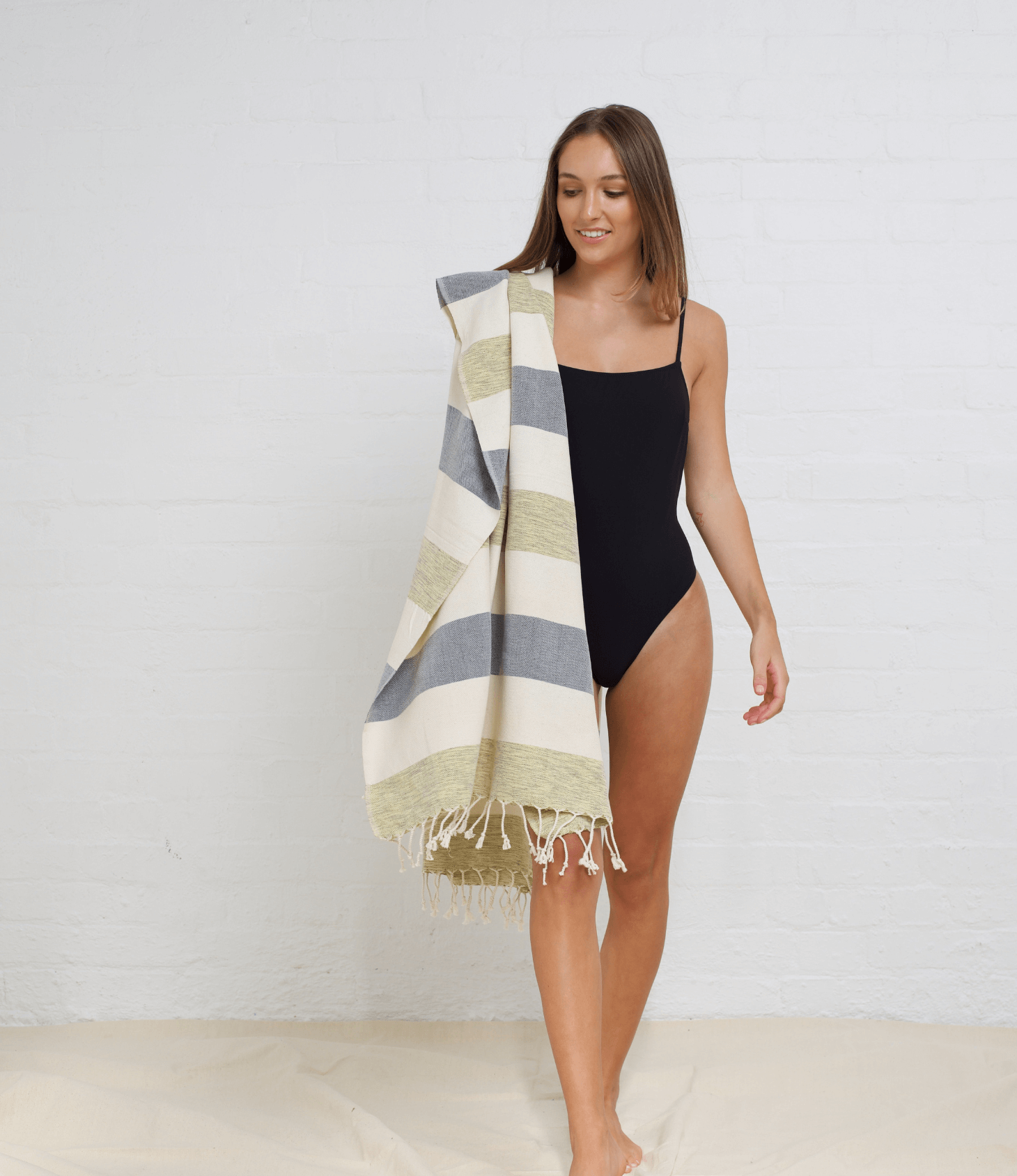 "Patara" Peshtemal Beach Towel  in Color: Green & Navy, draped over shoulder