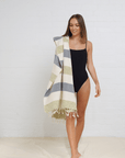 "Patara" Peshtemal Beach Towel  in Color: Green & Navy, draped over shoulder