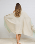 Woman wearing Kas Linen/Cotton peshtemal, showcasing its soft fabric and elegant design.