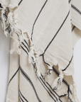 A premium linen "Kekova" Turkish towel in Beige with black stripes