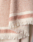 A dotted Turkish cotton "Kalkan" beach towel in copper red